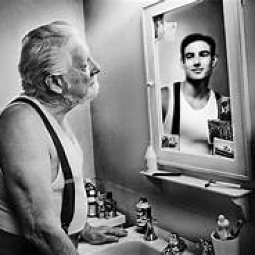 old man looking in mirror